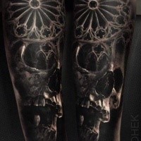 Detailed medieval style arm tattoo of human skull with ornament