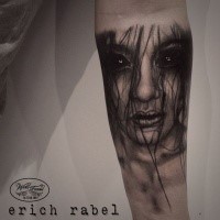 Detailed mystical looking forearm tattoo of demonic woman face