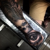 Detailed natural looking long cathedral tattoo on forearm combined with skull and human eye on hand
