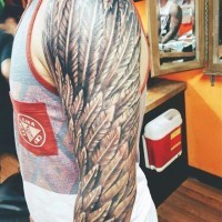 Detailed realistic feather wing black and white arm tattoo
