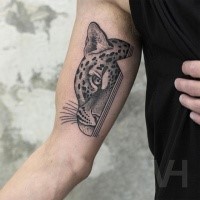 Dot style black ink biceps tattoo of leopard head with lines by Valentin Hirsch