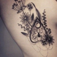 Dot style black ink side tattoo of wildflowers with arrow head