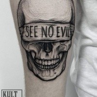 Dot style creepy looking arm tattoo of human skull with lettering