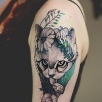 Dot style cute looking upper arm tattoo painted by Joanna Swirska of cat with flowers