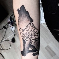 Dot style wolf shaped forearm tattoo stylized with mountains