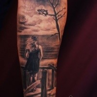 Dramatic black and gray style forearm tattoo of woman with tree and sea shore