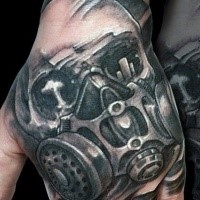 Dramatic black and white hand tattoo of skull in gas mask