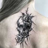 Dramatic black ink upper back tattoo of human skull with rose