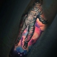 Dramatic designed colored astronaut with broken helmet tattoo on arm