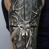Dramatic hunting themed black ink deer in rifle scope tattoo on arm