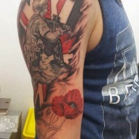 Dramatic military themed memorial tattoo on shoulder with soldier and flowers