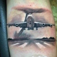 Dramatic realistic looking modern plane tattoo on arm combined with big hurricane