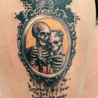Dramatic style painted old skeleton couple portrait with lettering tattoo on thigh