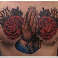 Dramatic style painted praying hands with flowers tattoo on chest