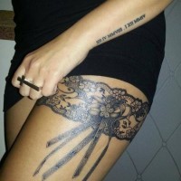 Elegant black lace garter thigh tattoo for women