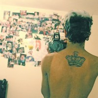 Elegant crown tattoo on the back for real men