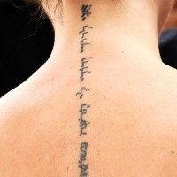 Elegant hebrew tattoo on back for girls