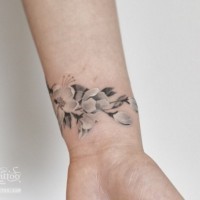 Elegant white and gray cherry blossom tattoo on wrist by Graffitoo