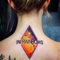 Emblem like colored hand tattoo of rhombus and lettering