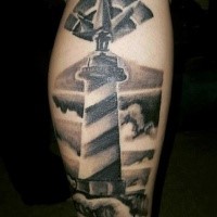 Engraving style black and white arm tattoo of lighthouse and clouds