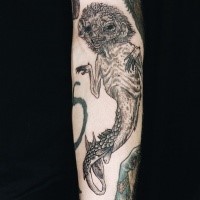 Engraving style black ink arm tattoo of demonic underwater animal