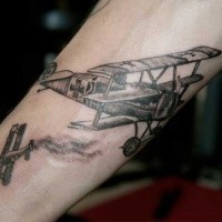 Engraving style black ink arm tattoo of WW1 planes