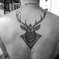 Engraving style black ink back tattoo of deer head with ornaments