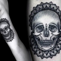 Engraving style black ink biceps tattoo of human skull with ornaments