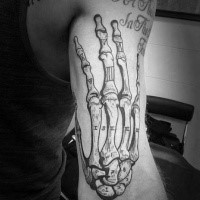 Engraving style black ink biceps tattoo of human skeleton hand