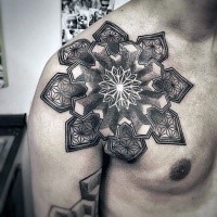 Engraving style black ink chest tattoo of cool looking flower shaped ornament