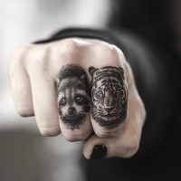 Engraving style black ink fingers tattoo of tiger and raccoon