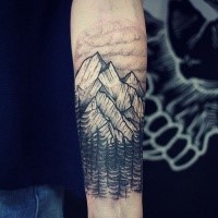 Engraving style black ink forearm tattoo fo mountain forest