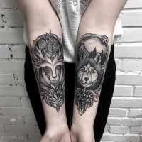 Engraving style black ink forearm tattoo of deer with wolf and flowers