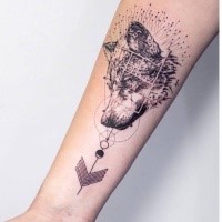 Engraving style black ink forearm tattoo of wolf head with ornaments