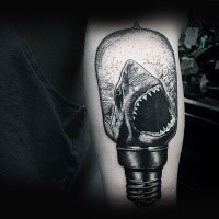 Engraving style black ink forearm tattoo of bulb with shark