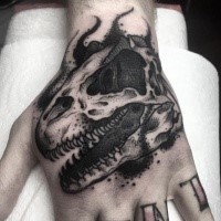 Engraving style black ink hand tattoo of dinosaur skull