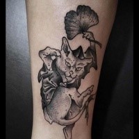 Engraving style black ink leg tattoo of evil cat with leaves