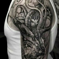 Engraving style black ink shoulder tattoo of creepy horror octopus