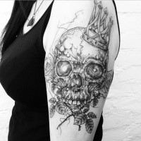 Engraving style black ink shoulder tattoo fo human skull with crown and roses