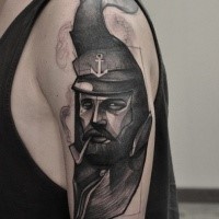 Engraving style black ink shoulder tattoo of smoking sailor face