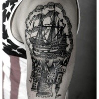 Engraving style black ink shoulder tattoo of old sailing ship with castle