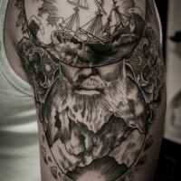 Engraving style black ink shoulder tattoo of man with beard with sailing ship