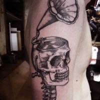 Engraving style black ink shoulder tattoo of large human skull combined with gramophone
