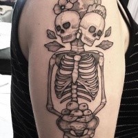 Engraving style black ink shoulder tattoo of human skull with two heads and flowers