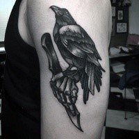 Engraving style black ink shoulder tattoo of cool crow with knife