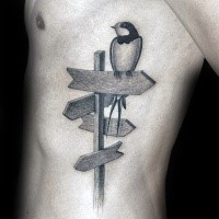 Engraving style black ink side tattoo of bird on road sign