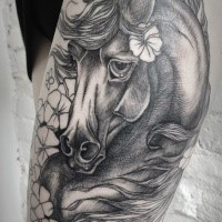 Engraving style black ink thigh tattoo of cute horse with flower