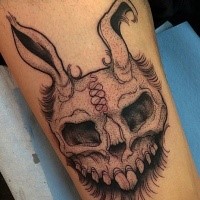Engraving style black ink thigh tattoo of evil rabbit skull