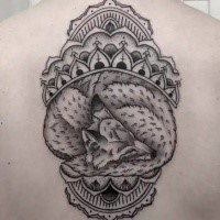 Engraving style black ink upper back tattoo of sleeping fox with Hinduism ornaments