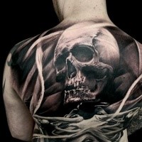 Engraving style colored back tattoo of human skull with skeleton
